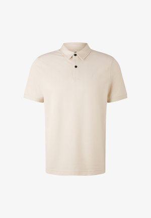 Beige Polohemd aus weichem Stoff, mit Kragen, kurzen Ärmeln, einer Knopfleiste mit zwei Knöpfen und einem kleinen Logo auf der Brust.