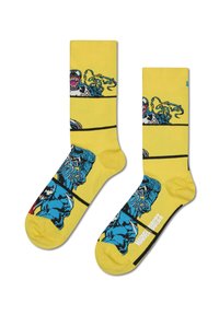 Chaussettes jaunes avec des motifs graphiques de personnages Marvel, dans une palette de couleurs bleu et noir, avec des rayures noires contrastantes.