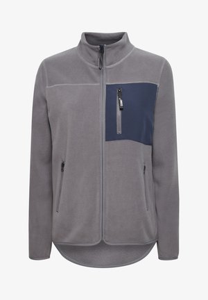 Svetrová bunda v šedej farbe s námořníckou panelom na hrudi. Má vysoký golier, dve bočné zipsové vrecká a zipsové vrecko na hrudi.
