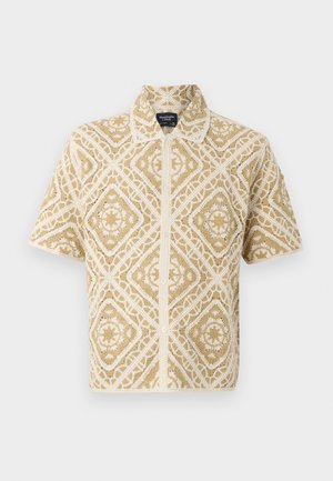 Short-sleeve beige and white crochet button-up shirt with geometric diamond and star pattern, flat collar, and Abercrombie & Fitch label.