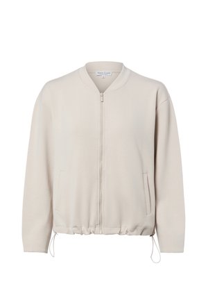 Veste beige à fermeture éclair avec manches longues, ourlet élastiqué avec cordons de serrage et poches latérales, présentée sur un fond blanc.