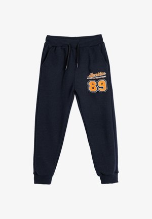 Navy Sweatpants mit elastischem Bund und Kordelzug, versehen mit einem aufgedruckten orangen Logo "Brooklyn Athletic Department" und der Nummer "89."