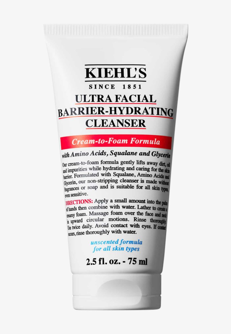 Limpiador Barrier-Hydrating Ultra Facial de Kiehl's en un tubo blanco de 75 ml. Presenta un texto rojo en negrita, una fórmula que pasa de crema a espuma y acentos azules.