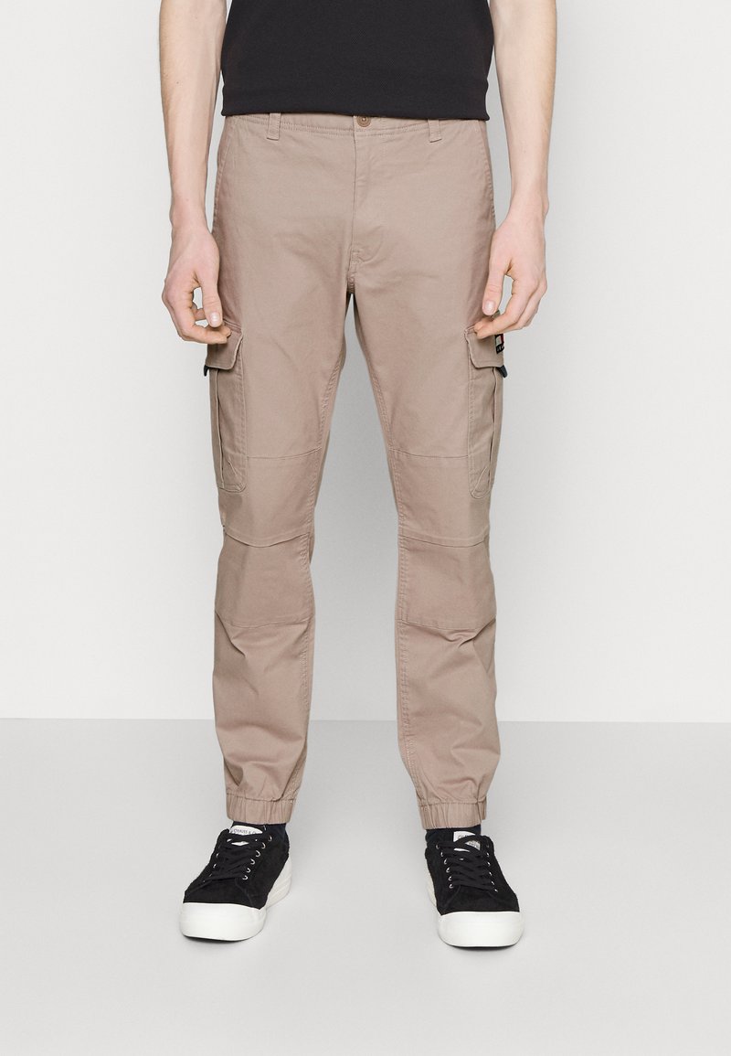 Lichtbeige cargo broeken met elastische boorden, zijzakken en een relaxed fit. Gemaakt van katoen met een gladde structuur.