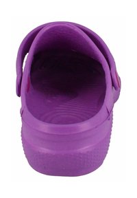 Purple rubber clog with a textured insole and circular pattern. Open back with a single adjustable strap on the side.