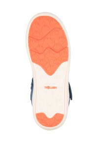 Footwear featuring a textured white and orange sole, with a geometric pattern. Upper part is blue suede with a hook-and-loop closure.