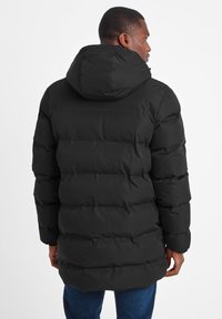 Black puffer jacket with a hood, featuring a boxy design and visible quilted sections. Smooth material with a matte finish.