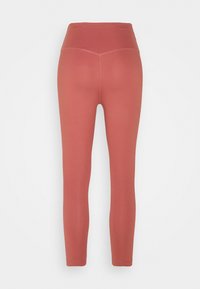 Leggings taille haute de couleur terre cuite, présentant une texture lisse, un design long et des détails de couture discrets le long des coutures.