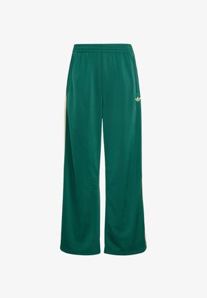 Pantalones deportivos de pierna ancha verdes con rayas laterales beige, cintura elástica y pequeño logo blanco de Adidas en el muslo derecho.