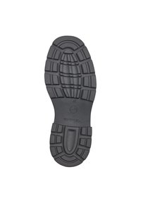 Semelle d'une chaussure noire avec des motifs de marche profonds et des rainures conçues pour l'adhérence et la durabilité, taille indiquée 37.
