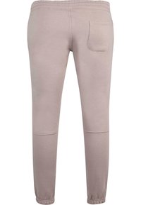 Lys beige sweatpants med elastisk talje og ankelmanchetter. Har en enkelt baglomme og en glat tekstur.