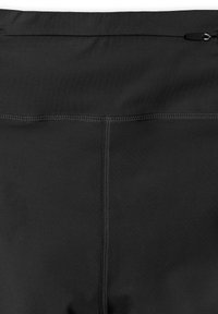 Gros plan sur un tissu noir avec des coutures verticales et horizontales et une petite tirette de fermeture éclair en haut.