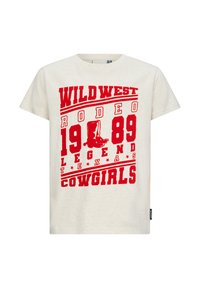 Kremowa koszulka z wyraźnym czerwonym nadrukiem: "WILD WEST RODEO 1989 LEGEND TEXAS COWGIRLS" oraz wizerunkiem kowbojskiego buta.