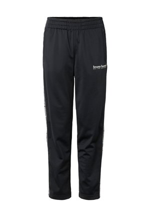 Schwarze elastische Trackpants mit seitlichem Streifendetail und kleinem weißen „bruno banani“ Logo am oberen Oberschenkel.