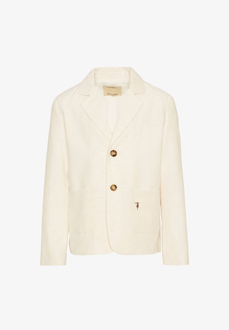 Blazer couleur crème avec deux boutons marron, revers crantés, poches avant et petit logo brodé sur la poche inférieure droite.