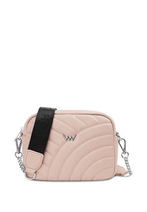 Schwarzes eng anliegendes Crop-Top, graue hochtaillierte Hose, weiße Turnschuhe und eine rosa gesteppte Handtasche. Glatte Texturen und neutrale Farbpalette.
