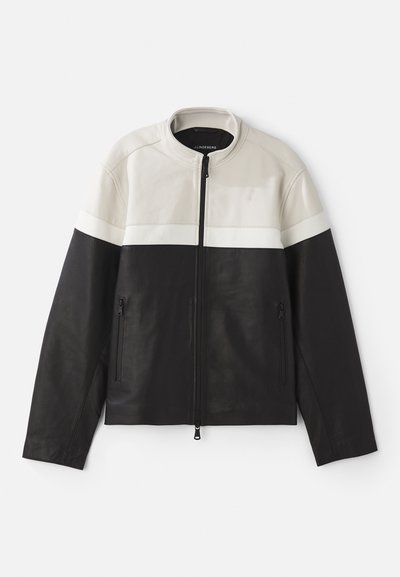 Leather jacket featuring a color-block design in cream and black, with a ribbed collar, zip closure, and side pockets. Smooth texture.