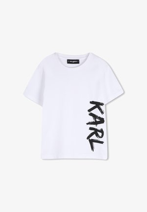 T-shirt bianca a maniche corte con scollo rotondo e la scritta nera audace "KARL" stampata verticalmente sul lato destro.