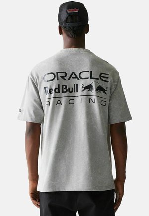 Mann trägt graues T-Shirt mit dem Logo und Design von "Oracle Red Bull Racing" sowie eine schwarze Netzkappe, von hinten vor weißem Hintergrund gezeigt.