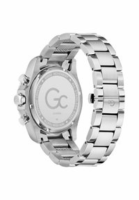 Zegarek ze stali nierdzewnej z metalową bransoletą, okrągłą kopertą i tarczami chronografu. Posiada wypolerowane wykończenie i grawerowany tył.