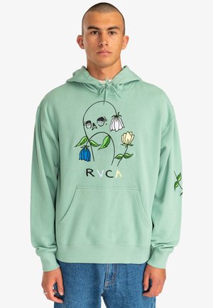 Mint green hoodie with front pocket, featuring embroidered skull and flower designs. Soft fabric and ribbed cuffs and hem. Brand logo visible.