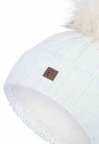 White knitted beanie with ribbed texture, featuring a tan leather patch and a fluffy pom-pom on top. Soft lining visible inside.