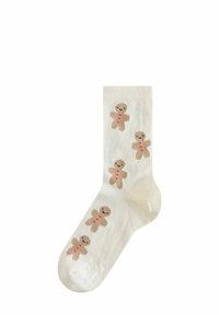 Calzino color crema con texture a coste, decorato con motivi di omini di pan di zenzero beige con bottoni rossi e faccine sorridenti.