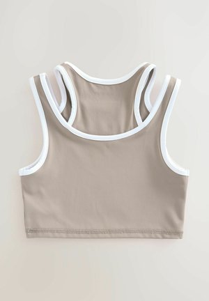 Top sportiv bej, scurt, cu margini albe, având un guler rotund și bretele late. Fabricat dintr-un material moale și elastic. Design simplu, fără modele.