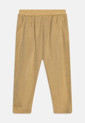 Beżowe legginsy wykonane z miękkiego, elastycznego materiału. Posiadają miękki pas, dwie boczne kieszenie oraz przeszycia na szwach. Prosty, smukły design.