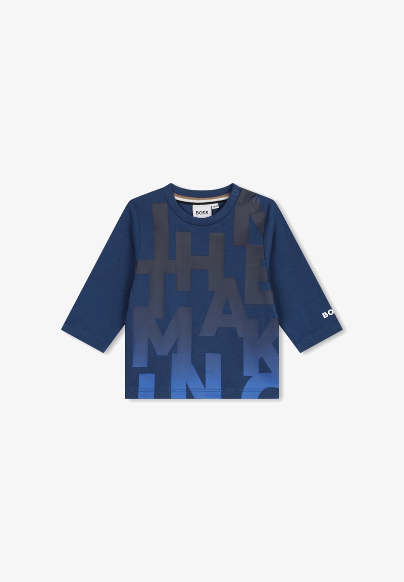 Chemise à manches longues bleu marine avec un grand imprimé en dégradé. Le tissu est en coton doux, avec un col rond et une fermeture à boutons pression à l'épaule.