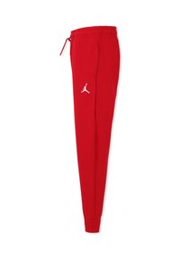 Rode trainingsbroek met een verstelbare taille, elastische boorden en een witte Jumpman-logo op de linkerdij. Gemaakt van zacht materiaal, met een tapered ontwerp.