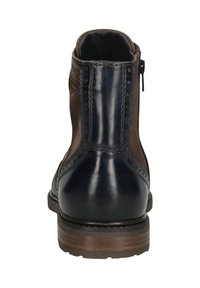 Schwarze und braune Lederstiefelette mit Reißverschluss an der Seite und Holzsohle, von hinten betrachtet.