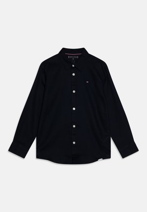 Camicia nera a maniche lunghe in tessuto tessuto, con colletto classico, chiusura a bottoni e piccolo logo sul lato sinistro del petto.