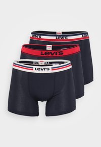 Tres pares de calzoncillos bóxer azul marino con la cinturilla distintiva de Levi's, con acentos en rojo y blanco contrastantes, hechos de una tela suave y elástica.