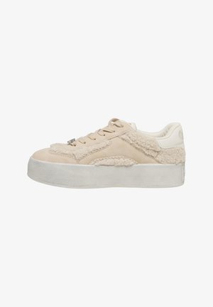 Beige sneaker with textured fabric and smooth leather. Features a thick white sole and laces, with fuzzy accents on the upper.