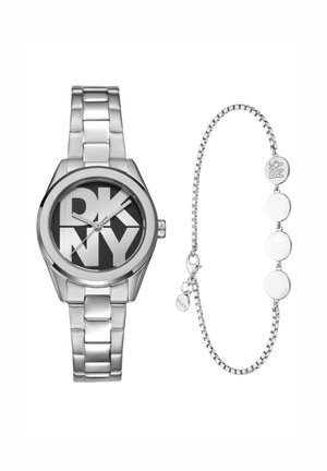Zilveren DKNY polshorloge met groot logo op een zwarte wijzerplaat en bijpassende zilveren armband met ronde bedels en een schakellinkontwerp.