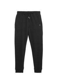 Schwarze Sweatpants mit elastischem Bund und verstellbarem Kordelzug. Aus weichem Stoff, mit schmal zulaufenden Beinen und einem kleinen Logo am linken Oberschenkel.