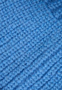Tessuto lavorato a maglia di un vivace colore blu, con un motivo testurizzato caratterizzato da punti in rilievo e una consistenza morbida e pelosa.