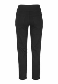 Svarta smala jeans med en åtsittande midja, som har två bakfickor, en mjuk textur och en tapered byxmodell.