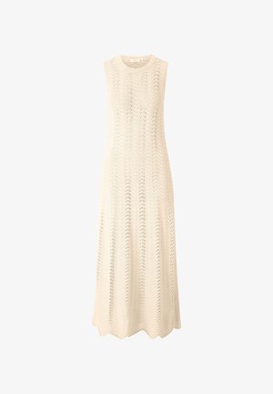 Knit sleeveless dress in a light cream color, featuring a wave pattern and a flowing, ankle-length silhouette with a rounded hem.