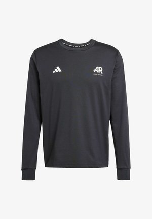 T-shirt de sport à manches longues noir en tissu lisse, arborant le logo et le texte Adidas blancs sur la poitrine, avec des poignets et un col côtelés.