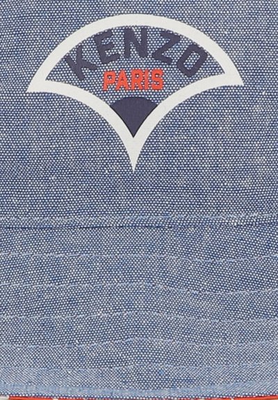 Chapeau seau en denim bleu avec un logo brodé blanc et rouge incluant "KENZO" et "PARIS" en majuscules. Tissu texturé avec des coutures visibles.