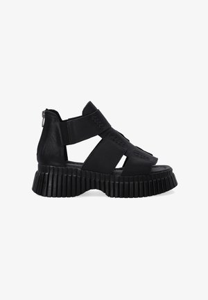 Zwarte leren sandalen met een stevige ribbelzool, open ontwerp met kruisbanden en een ritssluiting aan de zijkant voor gemakkelijk aan- en uittrekken.