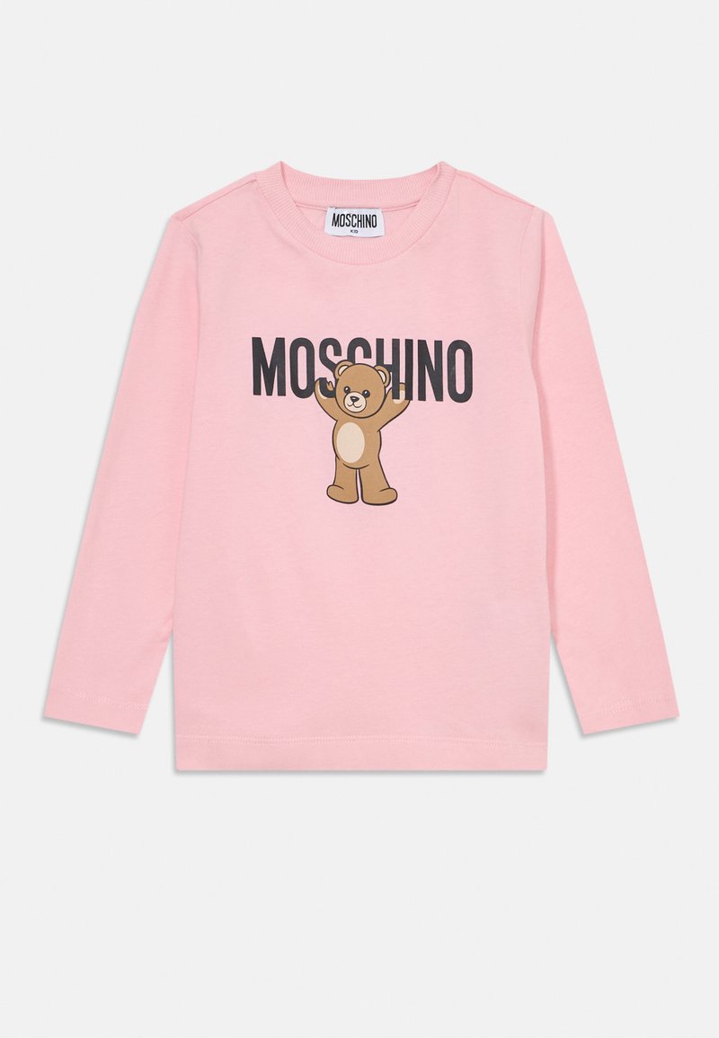 Rózsaszín, hosszú ujjú póló, puha textúrával, amelyen egy mesebeli medve látható, a "MOSCHINO" felirattal fekete betűkkel a mellkasán. Klasszikus kerek nyakkivágás.