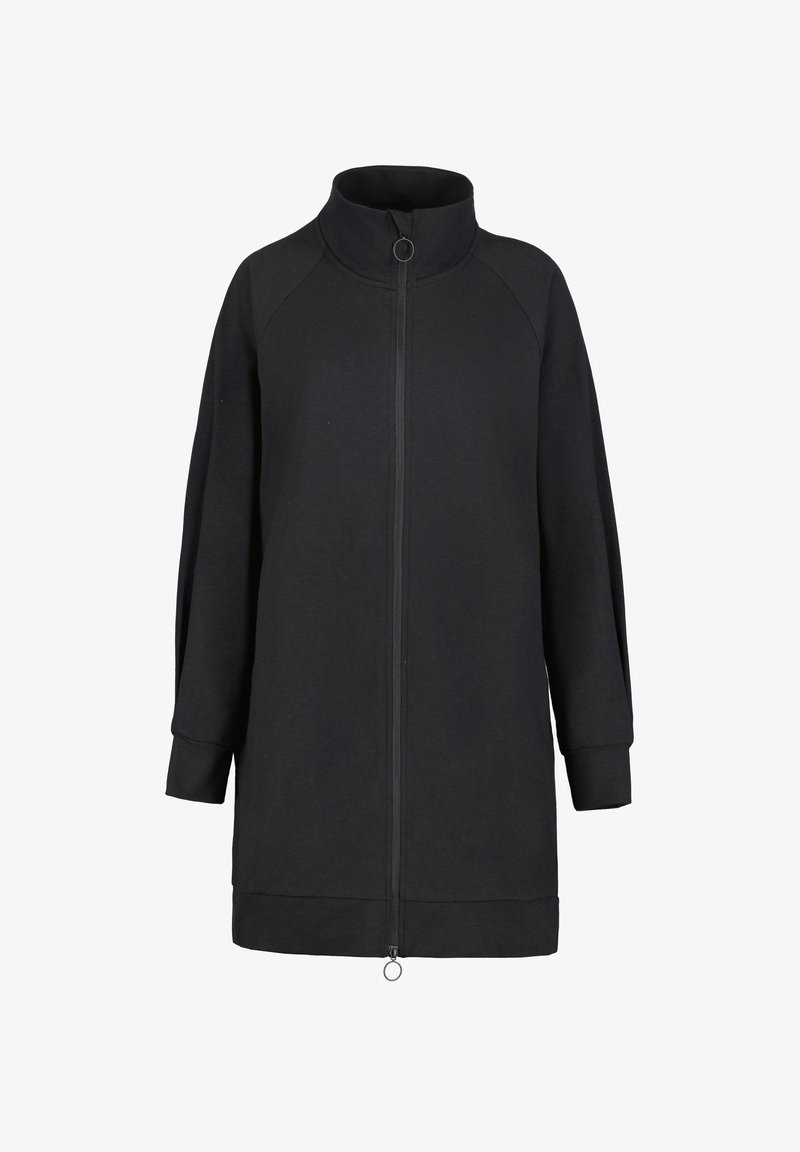 Veste noire à manches longues zippée avec col montant et tirettes de fermeture éclair circulaires à l'avant, manches avec poignets et ourlet droit.
