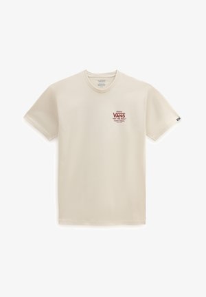 T-shirt beige Vans à manches courtes avec petit logo rouge "Vans Off The Wall" sur le côté gauche de la poitrine et petite étiquette noire sur la manche gauche.