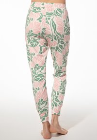Bloemmotieven leggings in pastelroze en groen, met een elastische tailleband, tapse pijpen en een zachte stofstructuur.