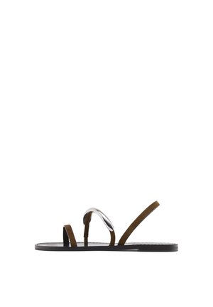 Flad sandal med tynde brune remme, hvoraf den ene har en sølvmetalisk accent, og en sort sål, set fra siden på en hvid baggrund.