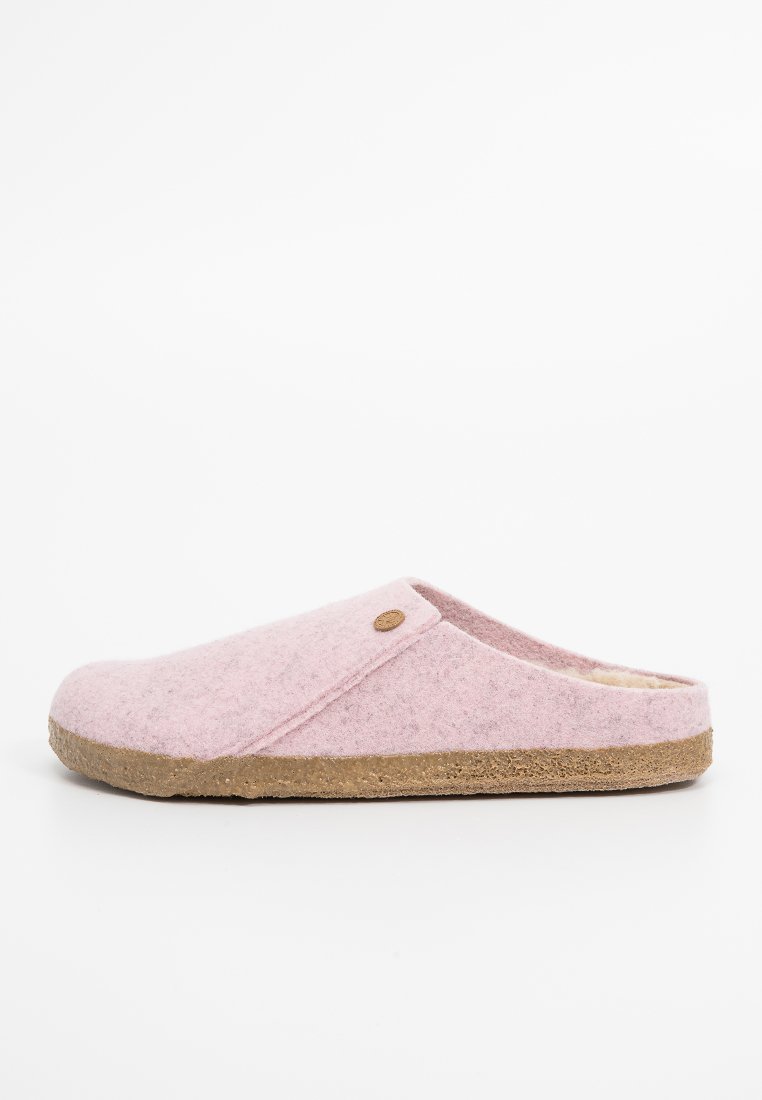 Pink felt slipper with a soft interior lining, rounded shape, slip-on design, and a textured brown rubber sole. Small logo accent on side.