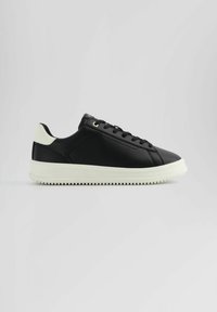 Black leather sneaker with round toe, white rubber sole, and black laces. Features a subtle logo on the tongue and contrasting heel detail.